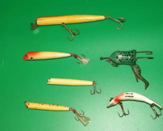 Lot 127. Heddon Prowler, Four unidentified stick baits, and a one-legged Italik frog.