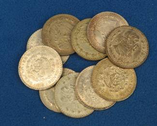 Lot 395. Ten Mexican one peso 10% silver coins. Dates range from 1957-1967.