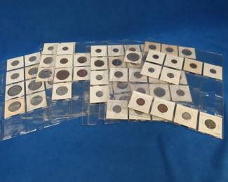Lot 403. Over 65 coins from around the world in plastic sleeves