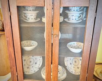 Antique pie safe with bottom drawer. Holding Churchill "Finlandia" china set.