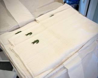 Box of white Lacoste Izon towel set with alligator log
