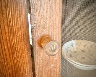 Antique pie safe with bottom drawer. Holding Churchill "Finlandia" china set.