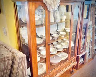 Antique glass china cabinet with bottom drawer, filled with MCM Rosenthal-Continental "Crystalline Blue" china set  