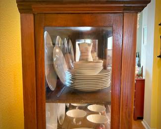 Antique glass china cabinet with bottom drawer, filled with MCM Rosenthal-Continental "Crystalline Blue" china set  
