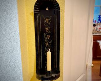 One of two black tin tole-painted candle sconces