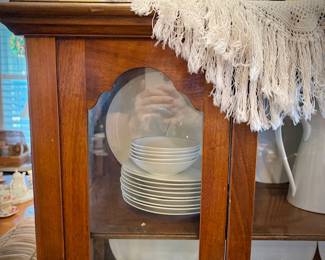 Antique glass china cabinet with bottom drawer, filled with MCM Rosenthal-Continental "Crystalline Blue" china set  
