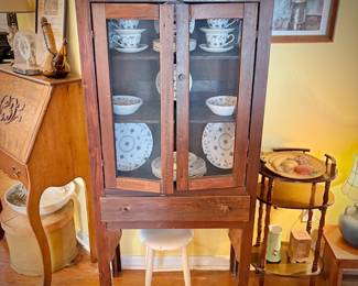 Antique pie safe with bottom drawer. Holding Churchill "Finlandia" china set.