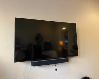 There are two beautiful Samsung flatscreen TVs and sound bars