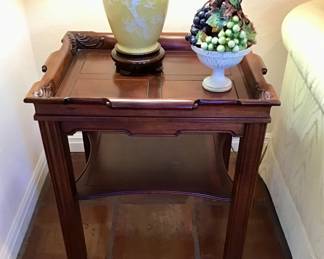 English Chippendale Mahogany side table with carved top to mimic a rolled handle. 