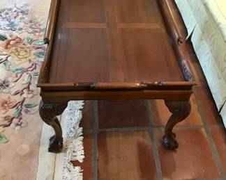 English Chippendale Mahogany coffee table with carved top to mimic a rolled handle. 