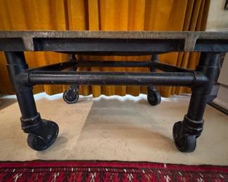 Brass and metal industrial style table on casters