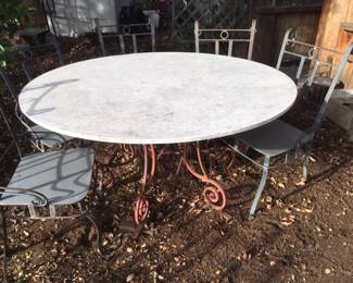 Marble top Iron table.  8 iron chairs