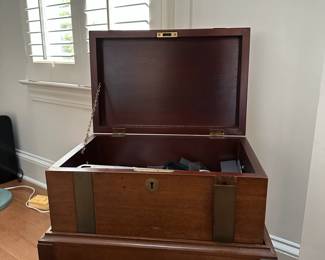 F48 - $50. Schott Chest on Stand. One band of trim needs reglued. Measures 18.75" wide x 13" deep x 21.5" tall. 