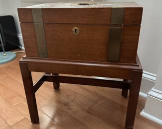 F48 - $50. Schott Chest on Stand. One band of trim needs reglued. Measures 18.75" wide x 13" deep x 21.5" tall. 