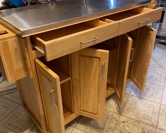 This is a PRE-SALE item - Rolling kitchen inland with expandable leaf - stainless steel top and storage - H 36" D 20 1/2" W 53" fully open.  Great functional piece!  Sold AS IS  - priced at $275 plus 7% sales tax.