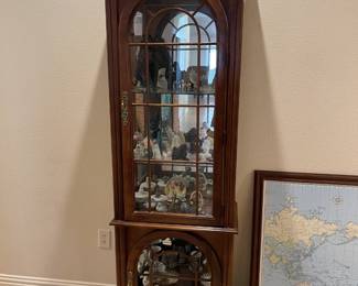 Lighted curio cabinet.  Glass is missing on the bottom section.