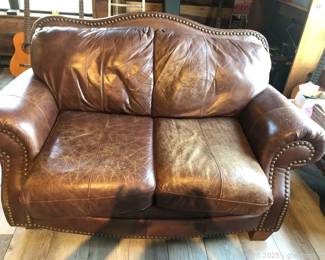 Well Loved Brown Leather Loveseat