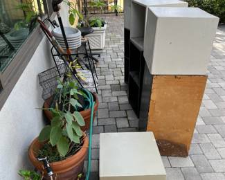 Outside, there are a number of potted plants as well as some cube storage shelves.  Rearrange them however you like.