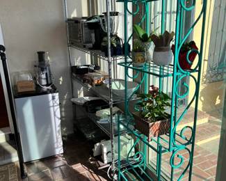 There are two more baker's racks in the sale, in this case holding several potted plants.