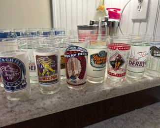 A collection of vintage Kentucky Derby and Breeders' Cup collectible glasses