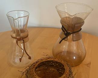 Eclectic Vases of Glass, Wood, and Leather along side a "bird's nest" basket!