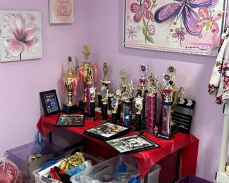 Juliet's Donendfeld room with her trophies, clothes bags and purses.