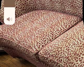 Another shot of the one of the pair of leopard print sofas.