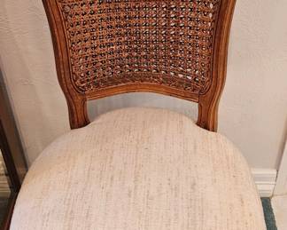 One of two cane-back side chairs