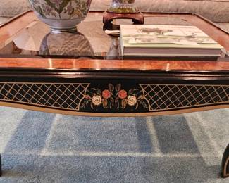 Black and gold coffee table with glass top