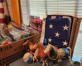 Several American Flags and collectible horses.