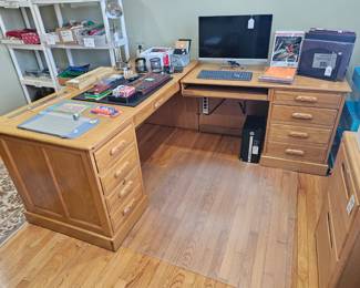 All wood (oak) desk with six drawers, pull out keyboard tray, and storage for hardrive. Its in two pieces for easy moving. Has matching two drawer legal size file cabinet