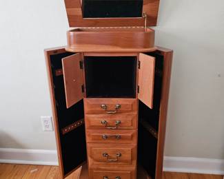 Nice oak ladies jewelry armoire with four doors, five drawers, and top that opens with mirror