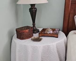 round table with bronze lamp