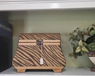 Woven basket with hinged top and greenery