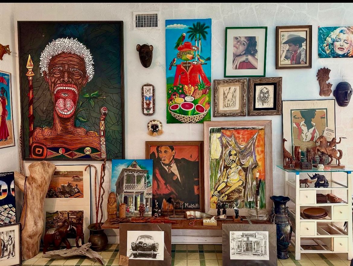 Eclectic mix of original oils paintings 1960's-70's. Large painting on the left is by Felipe Salvador, Afro-Brazilian artist from Angola. The title of this piece isFamine in Saba.
