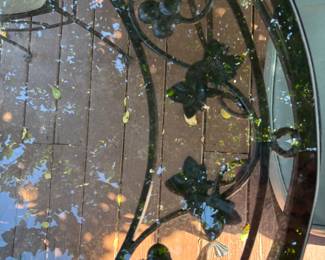 Wrought Iron Oval glass top Table with 4 chairs. T: 54”L 36”d 29.5”t. C: 16”x16”x 36”.  