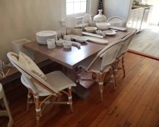 Serena & Lily Riviera Rattan dining chairs; trestle-style dining table & bench by West Elm