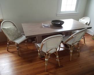 Serena & Lily Riviera Rattan dining chairs; trestle-style dining table & bench by West Elm