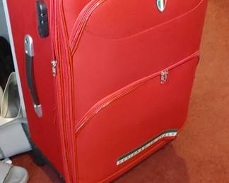 Nice red zipper modern suitcase on wheels