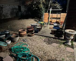 Lots of pots, stands and a baker's rack