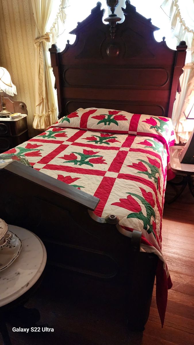 Gorgeous antique bed and handmade tulip quilt