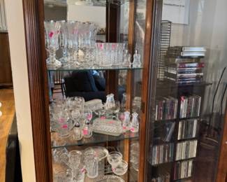 Lighted curio with glass collection