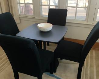 Like new 4 parson chairs and a tulip dining table.