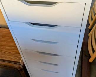 White Storage Unit with many pull out drawers.