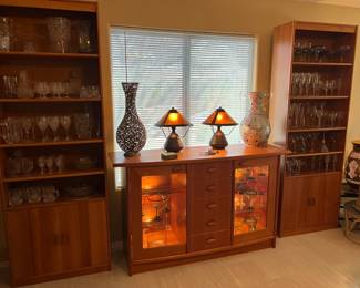 Scandinavian design lighted buffet and bookcases, lamps, cut glass, galssware.