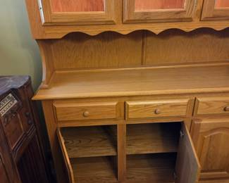 #36 Oak China Cabinet w/3 front glass doors w/1 glass shelf w/plate racks & 3 bottom doors and 1 shelf - lighted in excellent condition - 56x18x33-77 $225.00