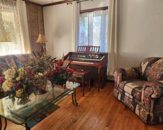 Beautiful living room furniture: sofa, chair, & loveseat, Lowrey organ, glass top coffee table, floral arrangements, lamps, vintage side tables,