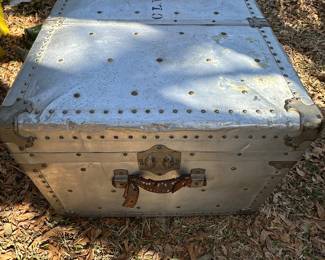 Aluminum footlocker with handle straps.
