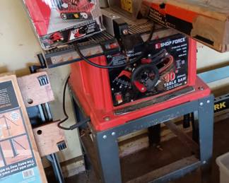 10" table saw with stand and box of attachments 
Belt sander 