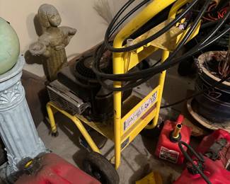 Power washer, gas cans, garden decorations.
